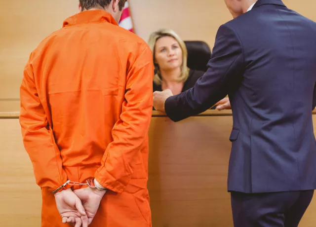 Capital murder detectives supporting legal defense in courtroom for high-stakes criminal case