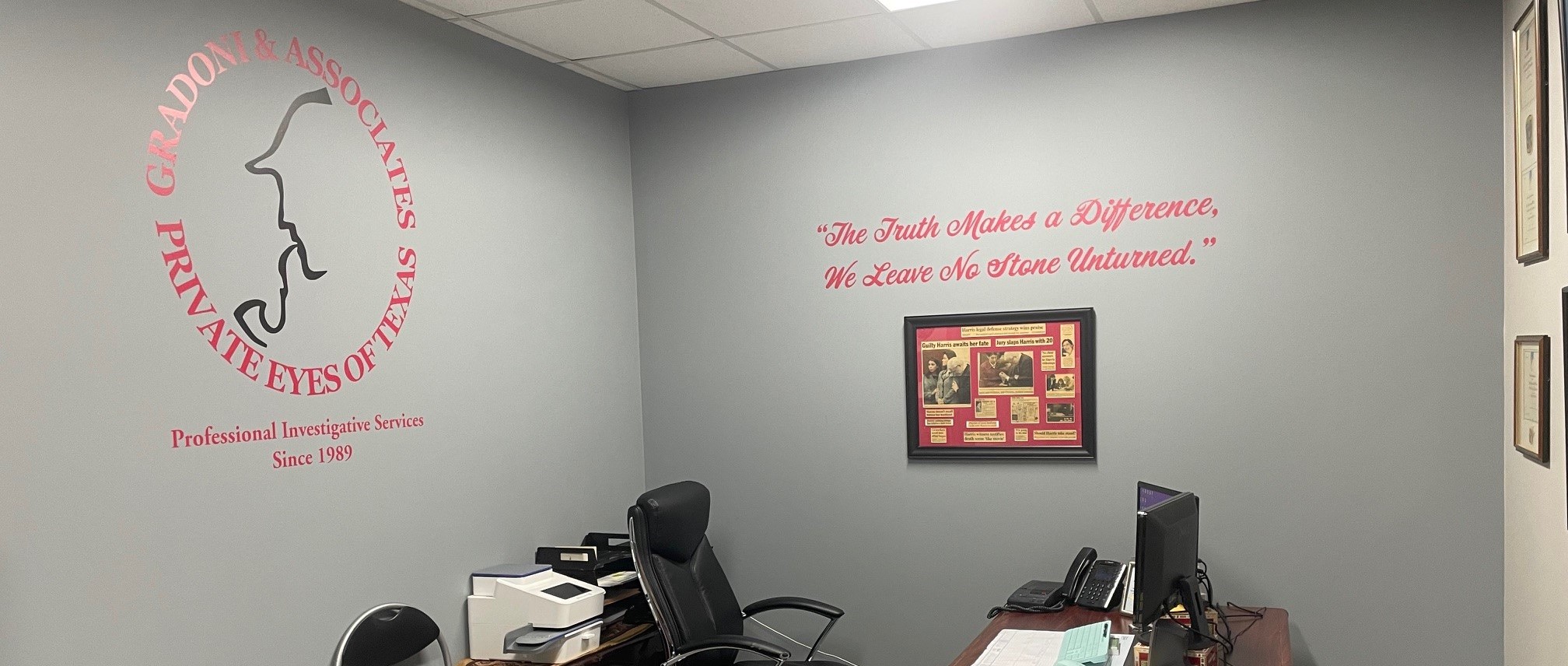 Office interior with Gradoni & Associates Private Investigators logo and desk setup