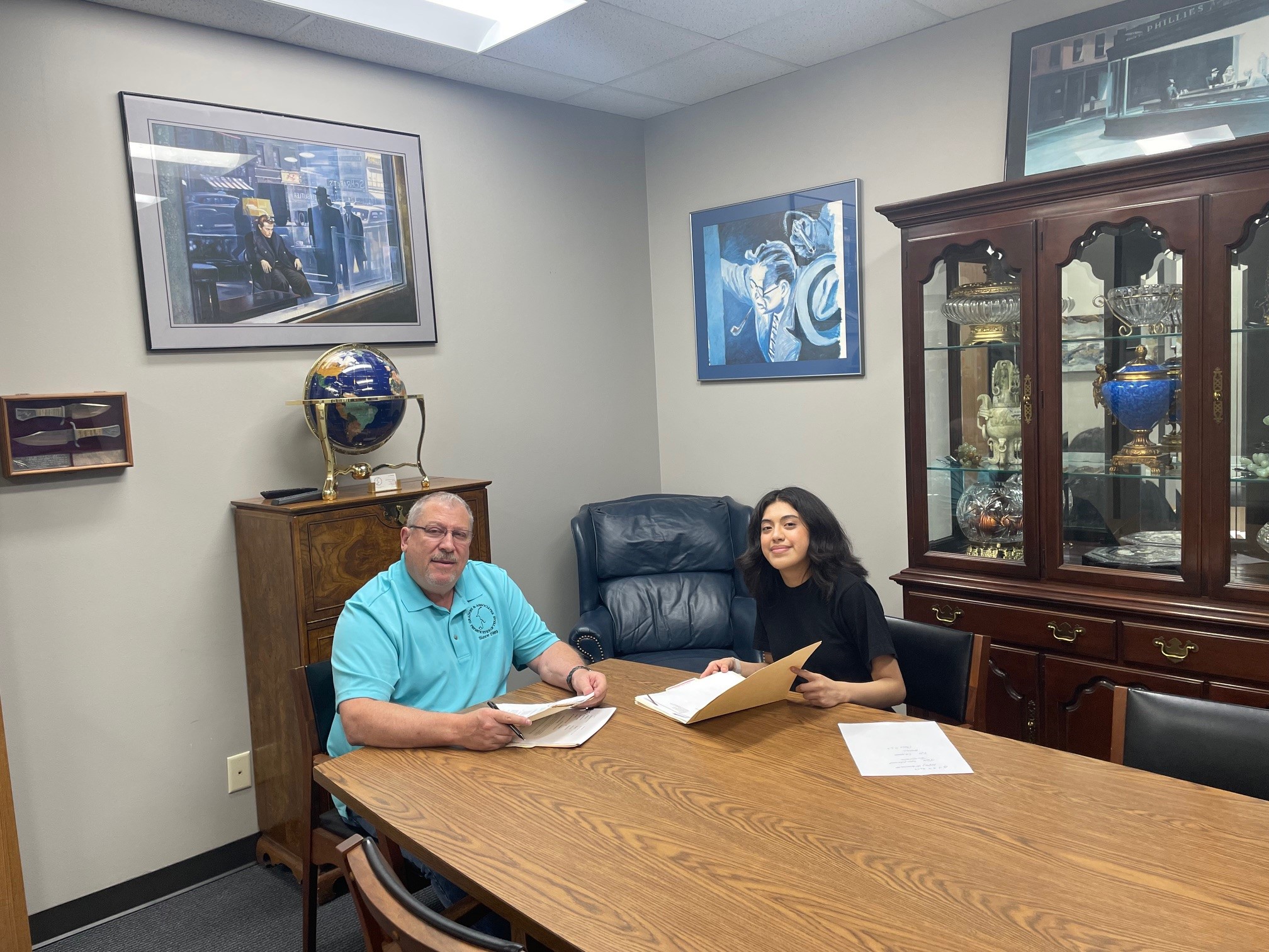 Private investigator in Houston team reviewing documents in office meeting room